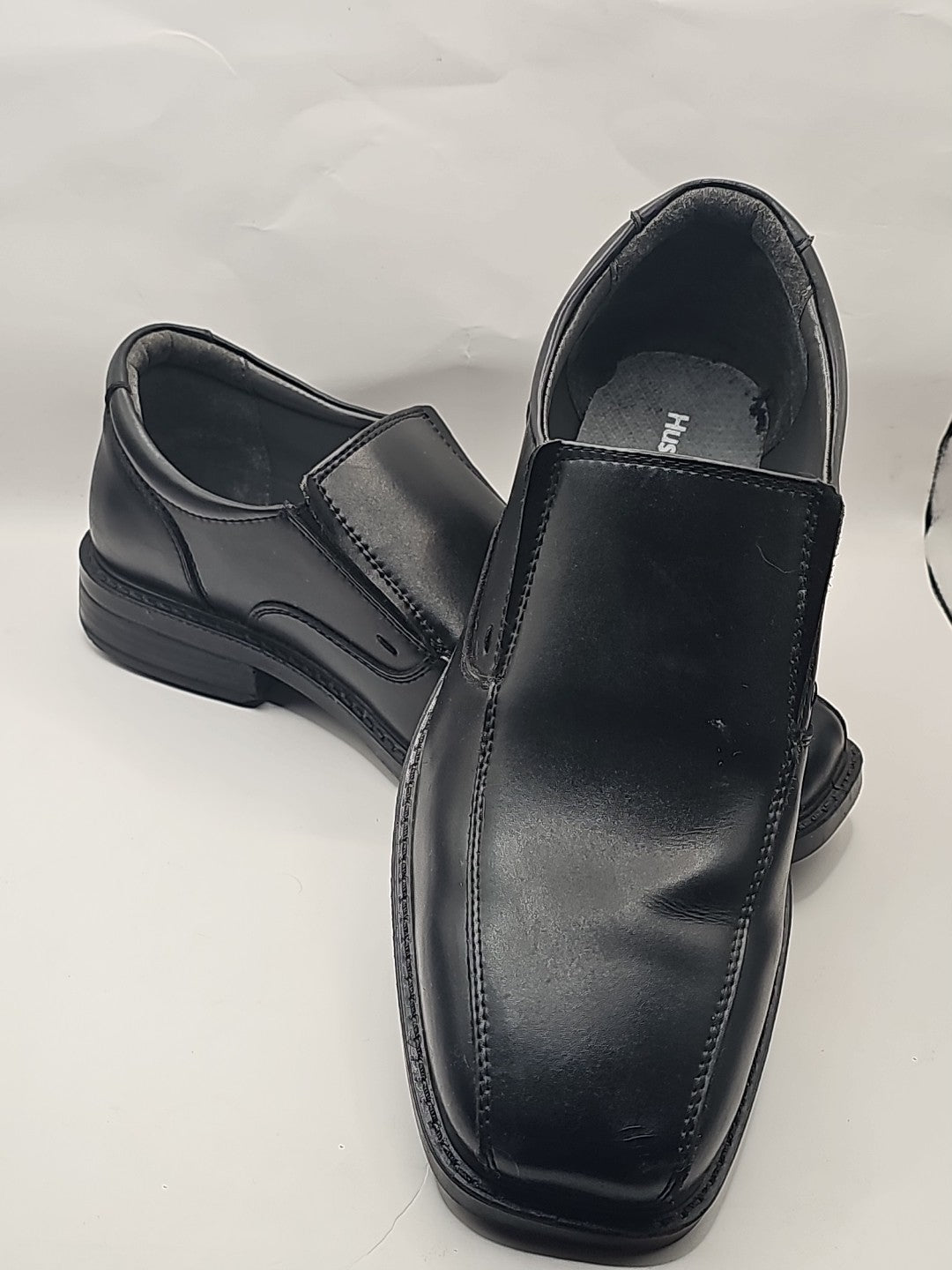 Mens Hush Puppies Black Leather Work Slip On Shoes Shock Absorbtion Bounce Tech cap/hat front (Image 1) — Second-Hand