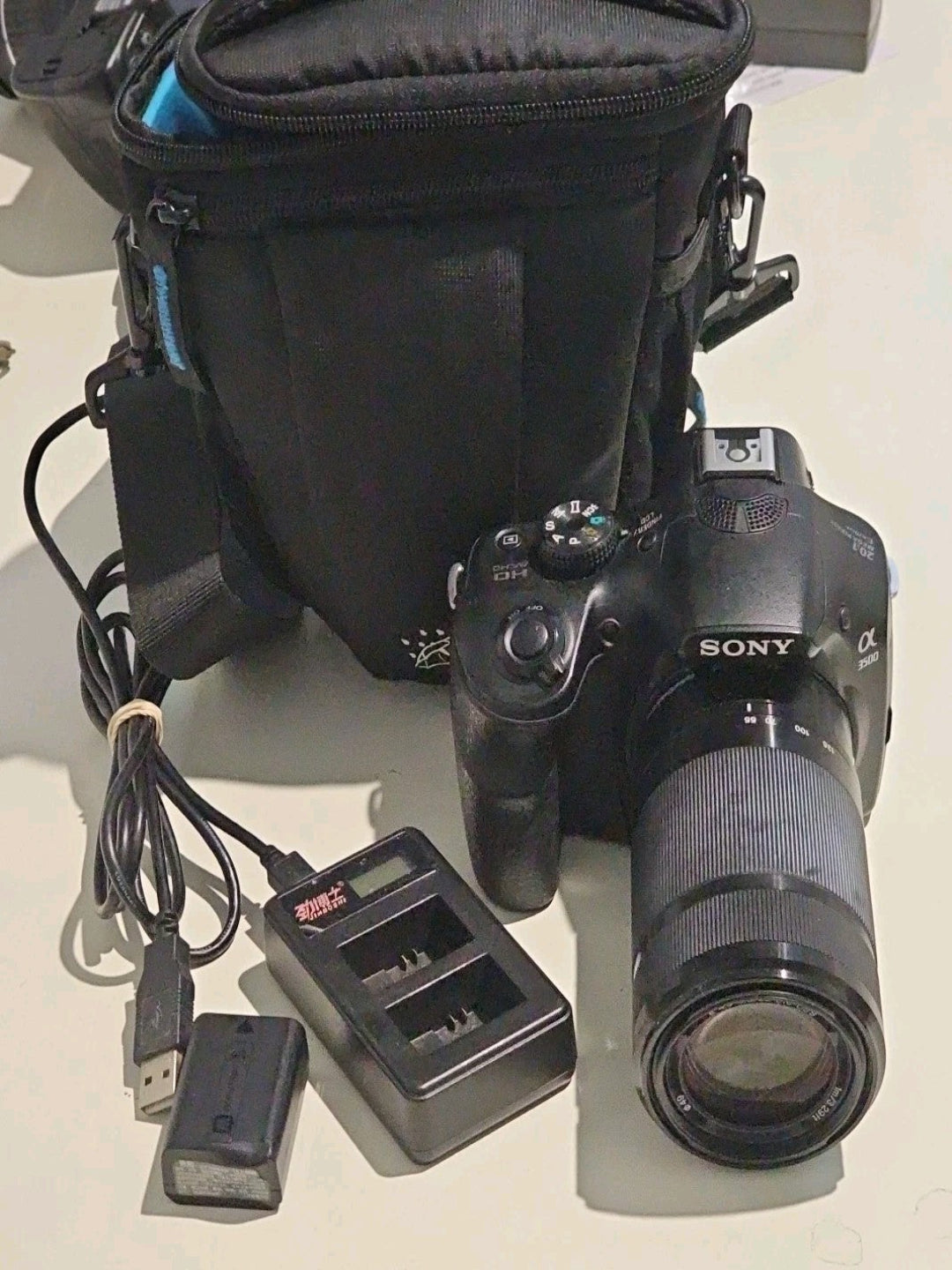Sony Alpha a3500 DSLR Camera + 55-210mm Lens + Battery Charger & Case Bundle device front (Image 1) — Second-Hand